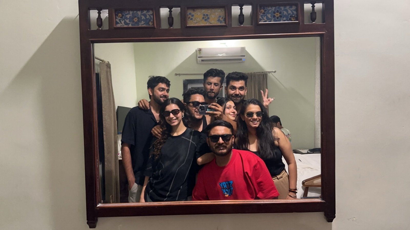 Friends taking an upright group mirror photograph