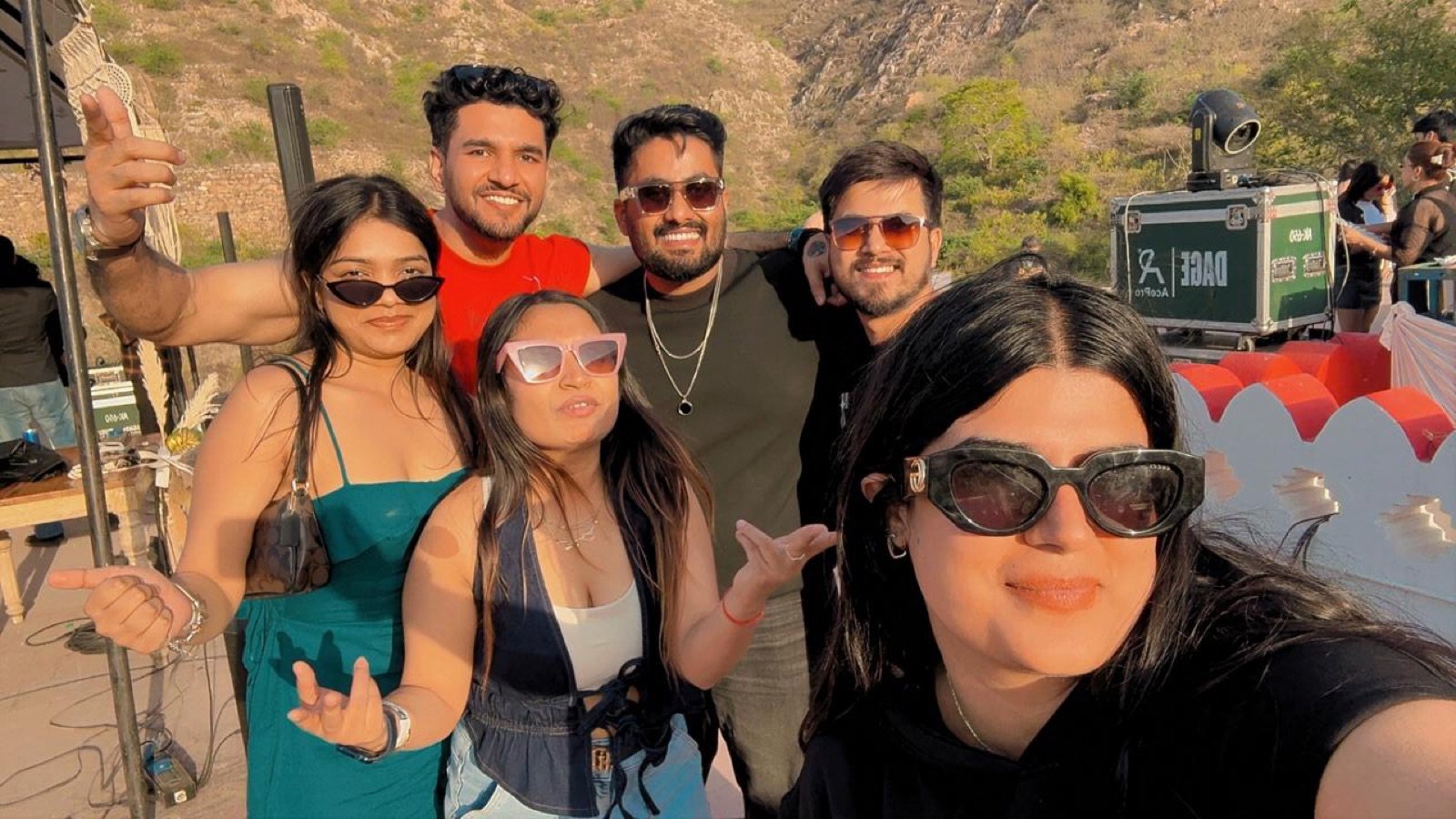 Friends taking an upright selfie at an outdoor festival